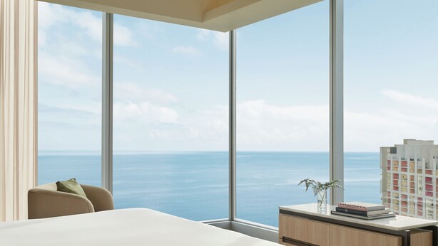 A modern hotel room with a large panoramic window offering a view of the sea and a distant cityscape. - Souma Hotel, Vignette Collection by IHG (Lima)