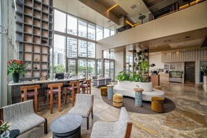 A spacious lobby with a bar area, seating, and a view of the cityscape. - Souma Hotel, Vignette Collection by IHG (Lima)
