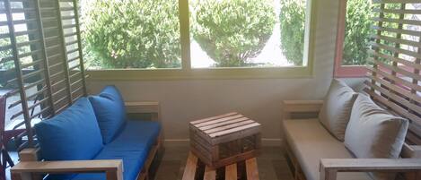 A cozy room with a blue sofa, a wooden coffee table, and a white sofa.