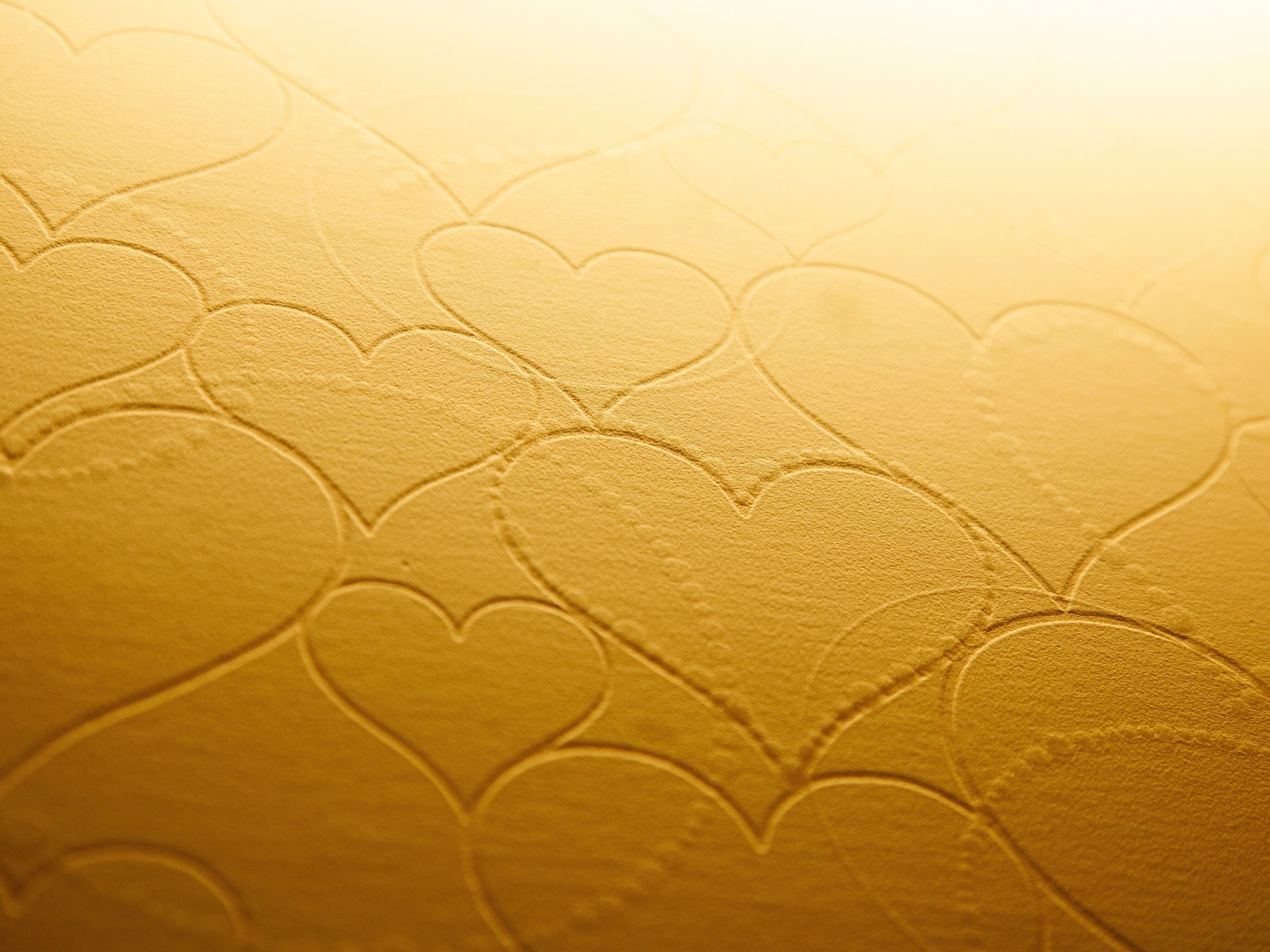 A textured surface with embossed heart shapes.