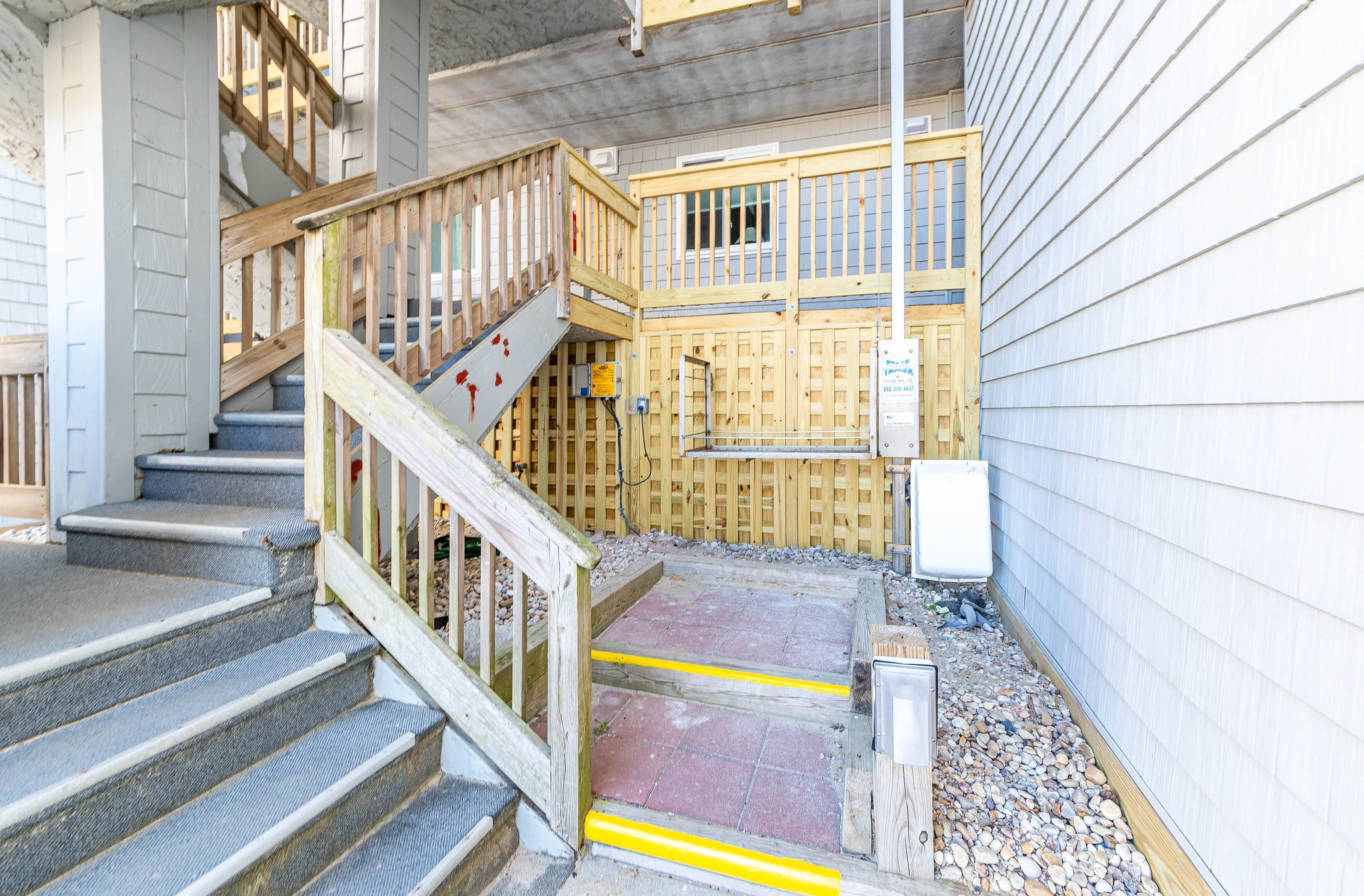 A staircase with wooden railings leading to a second-floor balcony.