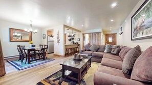 Relax and socialize in this inviting space with a plush sofa, dining area, and fully equipped kitchen.
