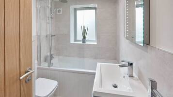 Bathtub, hair dryer, towels, soap