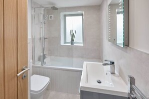 Bathtub, hair dryer, towels, soap
