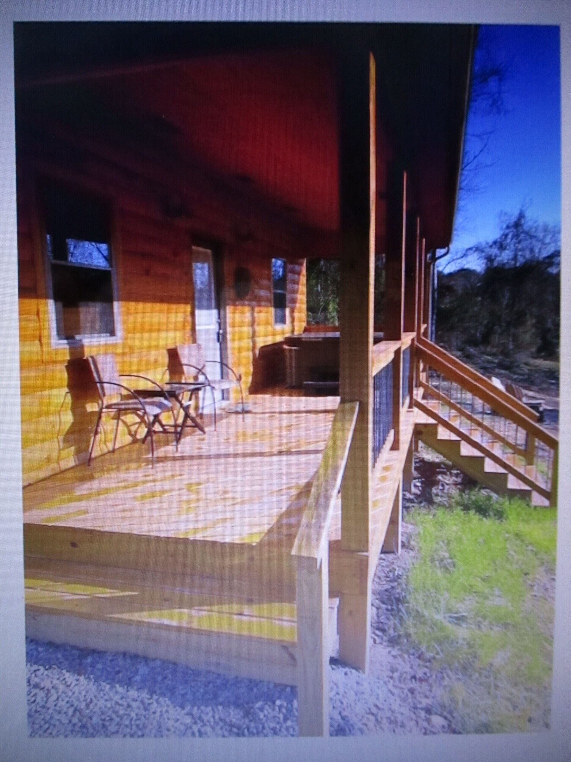 A cozy new cabin in rural setting with a hot tub on porch. Beautiful rural view.