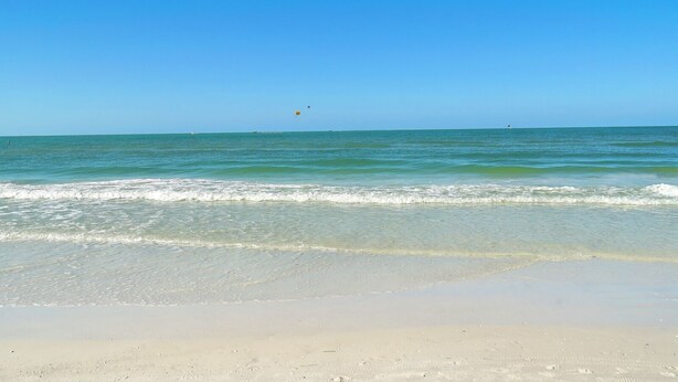 A beach with clear blue water and a sandy shore. - Siesta Key Village -Suite #2: A Block to the Beach, In the HEART of the Village! (Sarasota)
