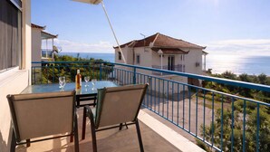 A balcony with a table, chairs, and a bottle of wine. - Koroni Seaview Retreat - Summer Romantic Escape (Koroni)