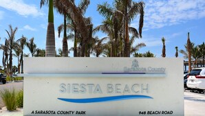 A sign for Siesta Beach, a Sarasota County park, with the address 948 Beach Road. - Siesta Cooler: Only Minutes Walk to Siesta Beach! (Siesta Key)