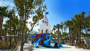 A playground with slides and a castle-like structure. - Siesta Cooler: Only Minutes Walk to Siesta Beach! (Siesta Key)