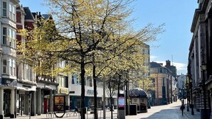 A street lined with trees and buildings, including a visible storefront with a sign that reads "The Works." - Central Nottingham Gem - Luxurious 2-bed Apartment (Nottingham)
