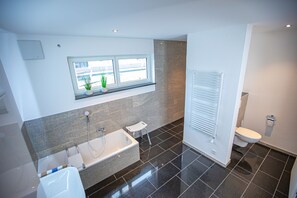 Bathtub, hair dryer, towels, soap