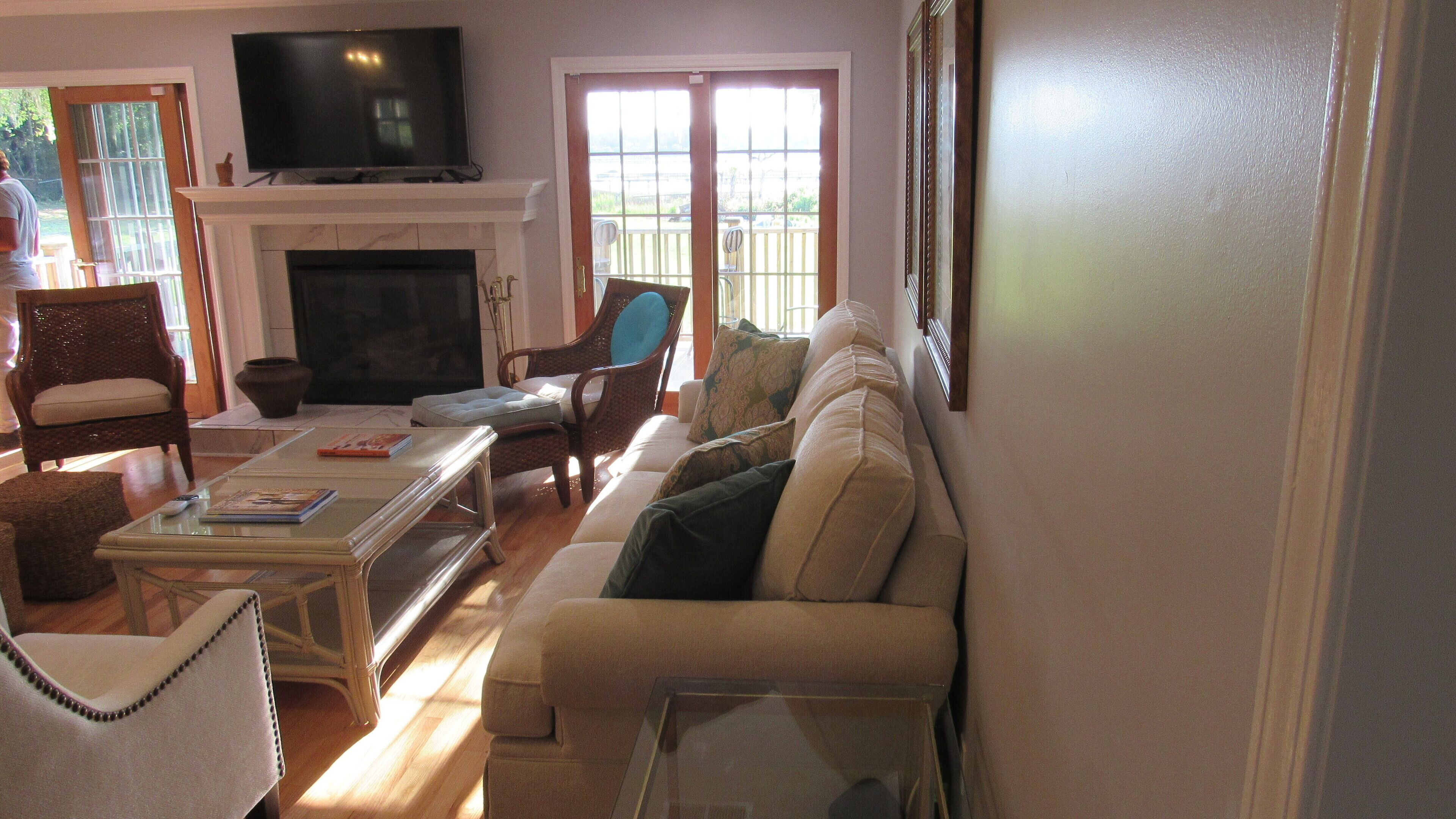 A living room with a fireplace, a television, and a sofa.