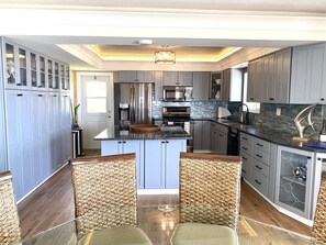 A modern kitchen with grey cabinets, stainless steel appliances, and a central island. - Oceanfront with Pool near Sombrero Beach (Marathon)