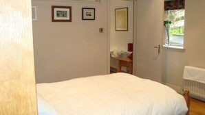 A bedroom with a single bed, a door, a window with a view, and a radiator. - Cosy flat with a great view, near the centre of Hebden Bridge  (Hebden Bridge)