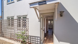 A modern building with a sign reading "Yew Tree Cottage." - Yew Tree Cottage is a modern eco-cottage (Westleton)