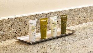 Four tubes of Verbena and Lavender body lotion on a tray against a speckled countertop. - Hilton Club The Central at 5th New York (New York)