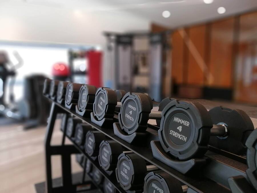 A rack of dumbbells with varying weights.