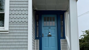 A house with a blue front door, white trim, and a set of wooden steps leading to the entrance. - Beautiful,  updated 3 bedroom home with parking for 6 cars in downtown Newport (Newport)