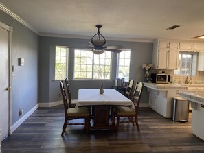 Enjoy meals with family and friends in this spacious dining area, complete with a large table and comfortable seating for four.