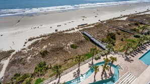 Um resort à beira-mar com piscina, acesso direto à praia e calçadão.