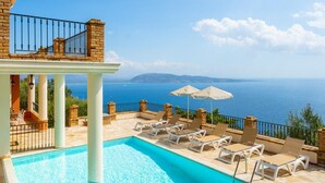 A swimming pool with lounge chairs and umbrellas, overlooking a scenic view of the sea and mountains. - Villa Emilios Large Private Pool Sea Views A C Wifi - 217 (Corfu)