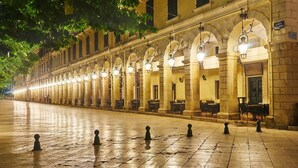 A long row of outdoor tables and chairs along a building with arched windows and light fixtures. - Dinos Walk to Beach Sea Views A C Wifi Car Not Required - 291 (Corfu)