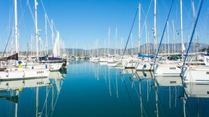 A marina with numerous sailboats docked in calm waters, reflecting the clear blue sky. - Porto Walk to Beach Sea Views A C Wifi Car Not Required - 385 (Corfu)