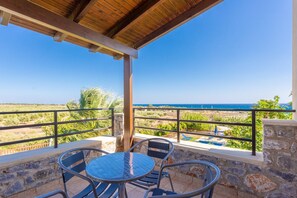 A covered outdoor area with a table and chairs, overlooking a pool and a view of the sea. - Spiros Beach Villa Large Private Pool Walk to Beach Sea Views A C Wifi Car Not Required - 971 (Sfakia)