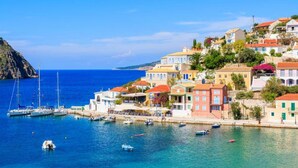 A coastal town with colorful buildings, a marina with boats, and a clear blue sea. - Villa Vali Large Private Pool Walk to Beach Sea Views A C Wifi Car Not Required - 1019 (Kefalonia)