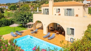 A modern villa with a swimming pool, outdoor seating, and a view of the surrounding landscape. - Villa Katerina Large Private Pool Walk to Beach Sea Views A C Wifi Car Not Required - 1021 (Kefalonia)