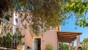 A stone staircase leading to a building with a pink facade, outdoor seating, and a pergola. - Villa Petros Large Private Pool Walk to Beach Sea Views A C Wifi Car Not Required - 180 (Corfu)