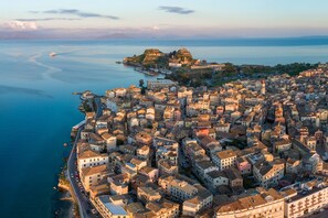 A coastal town with historic buildings, a fort, and a marina.