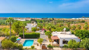 A coastal property with a swimming pool, white buildings, and a view of the sea. - Villa Eleni Large Private Pool Walk to Beach Sea Views A C Wifi Car Not Required Eco-friendly - 1840 (Pegeia)