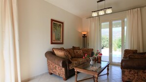 A living room with a sofa set, a glass coffee table, a floor lamp, and a painting on the wall. - Villa Ismini Large Private Pool A C Wifi Eco-friendly - 1877 (Kefalonia)