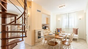 A modern kitchen with a built-in oven and a dining area with a wooden table and chairs. - Villa Fedra Large Private Pool Walk to Beach A C Wifi Car Not Required Eco-friendly - 1878 (Kefalonia)