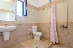 A bathroom with a sink, toilet, and shower.