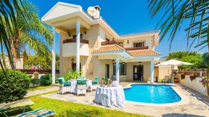 A two-story house with a swimming pool, outdoor seating, and a garden. - Villa Charianna Large Private Pool Walk to Beach Sea Views A C Wifi Car Not Required Eco-frie - 1985 (Ayia Marina Chrysochous)