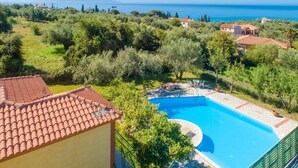 A pool with a clear view of the sea, surrounded by greenery and houses. - Villa Russa Dionisis Large Private Pool Walk to Beach Sea Views Wifi Car Not Required - 2017 (Kefalonia)