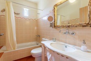 A bathroom with a bathtub, toilet, sink, and a large mirror. - Villa Almira Large Private Pool Walk to Beach Sea Views A C Wifi Car Not Required - 2080 (Mylopotamos)