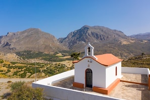 Perched on a rooftop, this charming church offers a serene view of the surrounding mountains.