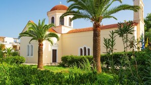 A building with a red-tiled roof, a bell tower, and a cross on top. - Villa Liakada Large Private Pool Walk to Beach Sea Views A C Wifi Car Not Required - 2081 (Mylopotamos)