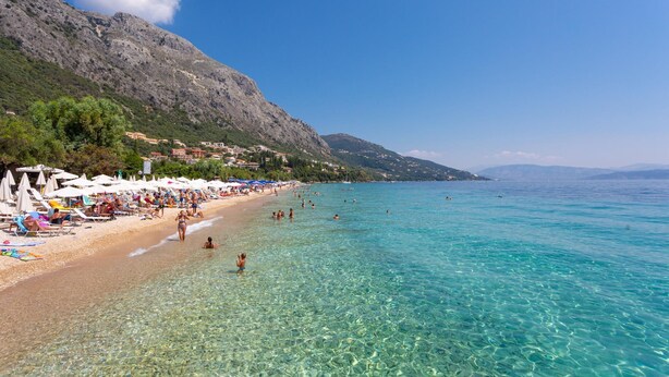 A beach with clear water, umbrellas, and people. - Villa Amalia Large Private Pool Walk to Beach Sea Views A C Wifi - 2120 (Corfu)