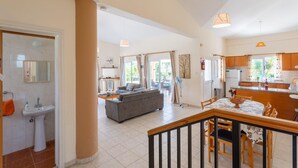 A spacious living area with a sofa, dining table, and kitchen. - Villa Chrystalla Large Private Pool Walk to Beach Sea Views A C Wifi - 2186 (Neo Chorio)