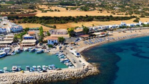 An aerial view of a coastal town with a marina, beach, and residential buildings. - Villa Chrystalla Large Private Pool Walk to Beach Sea Views A C Wifi - 2186 (Neo Chorio)
