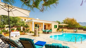 A poolside area with lounge chairs, a small building, and a clear blue pool. - Villa Constantinos Large Private Pool Walk to Beach Sea Views A C Wifi Car Not Required - 2220 (Ayia Marina Chrysochous)