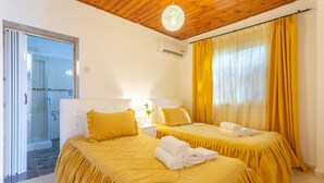 A hotel room with two beds, a shower area, and a wooden ceiling. - Villa Constantinos Large Private Pool Walk to Beach Sea Views A C Wifi Car Not Required - 2220 (Ayia Marina Chrysochous)