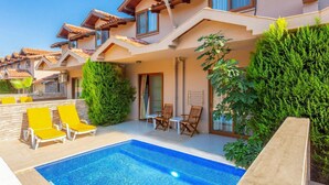 A modern hotel with a swimming pool, outdoor seating, and lush greenery. - Villa Melek Paradise Private Pool A C Wifi Car Not Required Eco-friendly - 2235 (Ortaca)