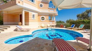 A two-story building with a swimming pool, outdoor seating, and a clear sky. - Villa Asimenia Large Private Pool Sea Views A C Wifi Eco-friendly - 2388 (Rethymno)