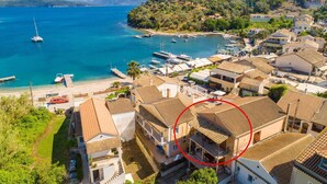 A coastal town with terracotta-roofed buildings, a marina, and boats. - Fay Apartment Walk to Beach Sea Views A C Wifi Car Not Required - 2617 (Corfu)