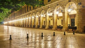 A long, illuminated corridor with arched ceilings and evenly spaced columns, leading to a building entrance. - Fay Apartment Walk to Beach Sea Views A C Wifi Car Not Required - 2617 (Corfu)